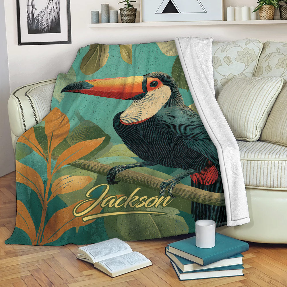 Toucan blanket draped over a sofa with vibrant tropical foliage and cozy reading scene