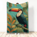 Toucan throw blanket with colorful tropical bird artwork and leafy botanical background