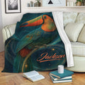 Toucan throw blanket displayed on a cozy sofa with colorful tropical bird artwork