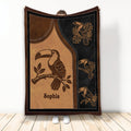 Custom toucan blanket with tropical bird artwork in brown, tan, and black tones