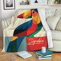 Colorful toucan throw blanket draped over a sofa in a cozy living room setting