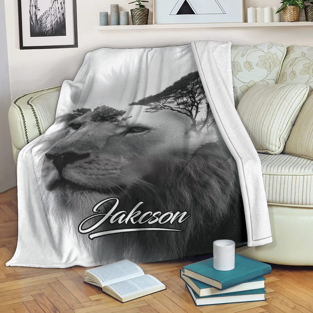 Lion throw blanket draped over a sofa with monochrome African wildlife artwork