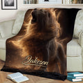Majestic lion throw blanket displayed on a sofa with radiant mane and dark artistic background