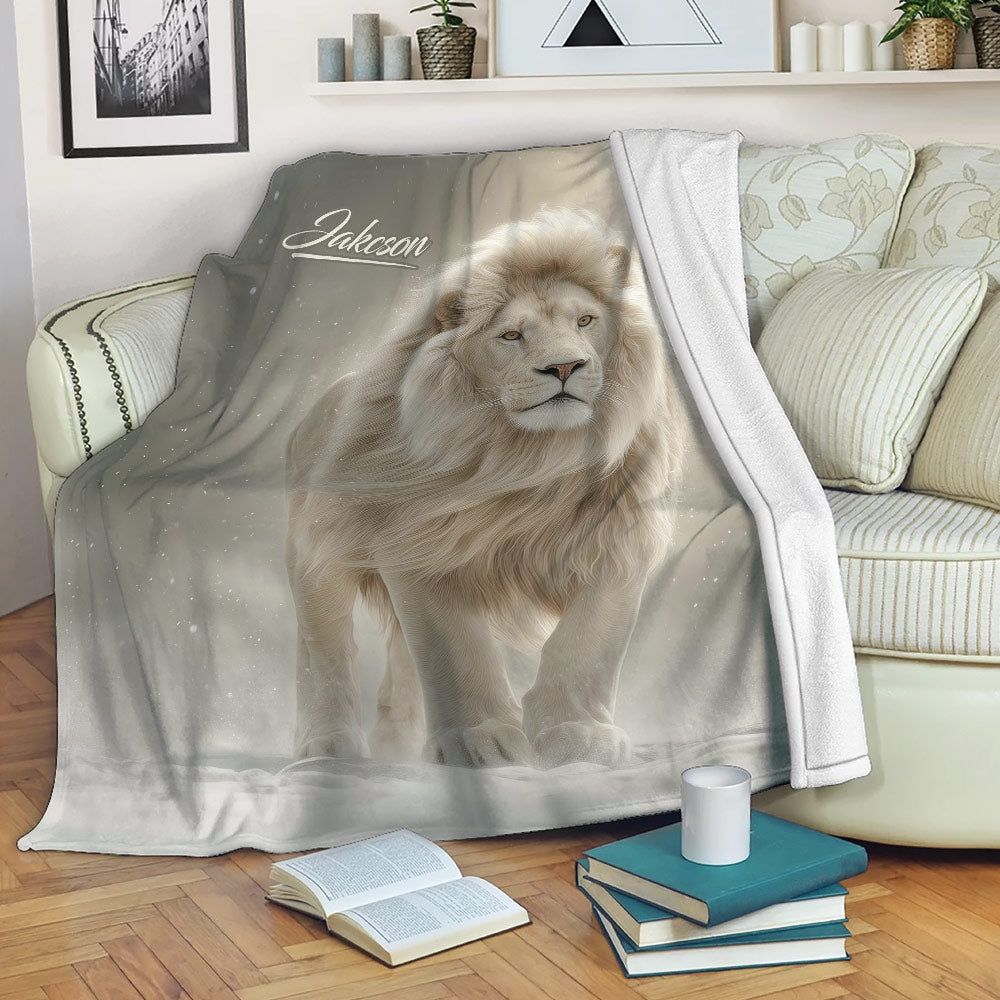 Lion blanket draped over a sofa, featuring a majestic white lion and soft winter-inspired artwork