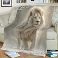 Close view of a lion throw blanket showcasing a detailed white lion against a dreamy gray background