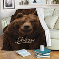 Brown bear throw blanket draped across a sofa in a cozy living room setting