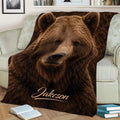 Close-up brown bear throw blanket styled on a sofa with books and home decor