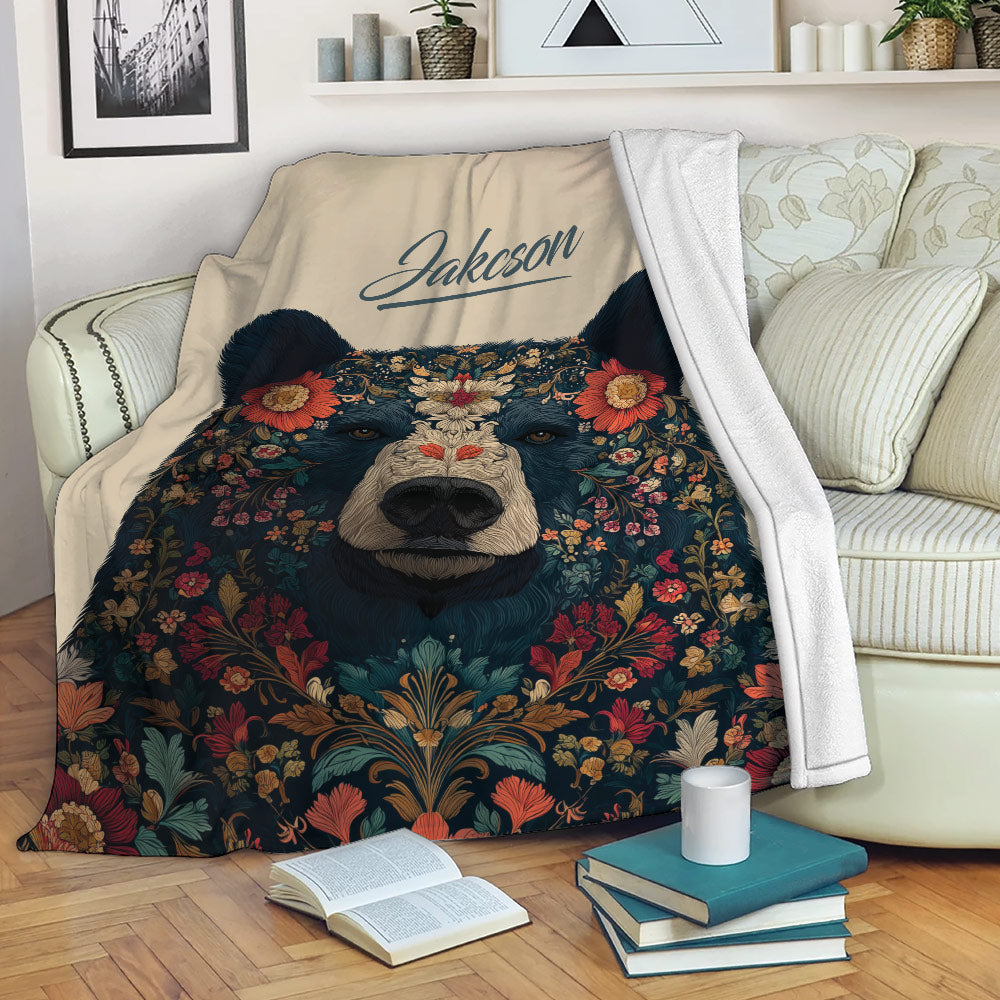 Floral bear throw blanket styled on a sofa with cozy reading and bedroom decor details