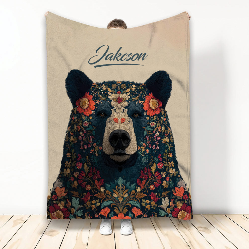 Bear throw blanket featuring a floral forest-inspired design in dark blue, cream, and warm autumn colors