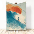 Surfing throw blanket with a silhouetted surfer riding a turquoise wave in colorful coastal artwork