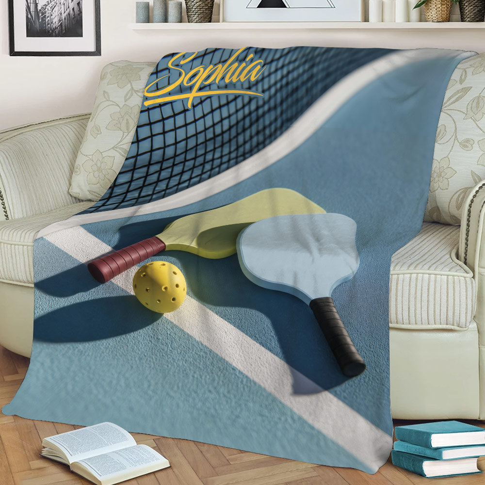 Close view of pickleball blanket artwork featuring paddles, ball, and net