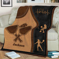 Close view of pickleball throw blanket featuring crossed paddles, a perforated ball, and player silhouettes