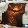 Glowing phoenix blanket draped over a sofa with vibrant ember-like artwork and dramatic wings