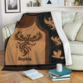 Phoenix blanket draped over a sofa with bold copper, brown, and black artwork