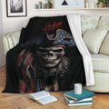 Pirate skull throw blanket displayed on a sofa with bold dark artwork and nautical character details