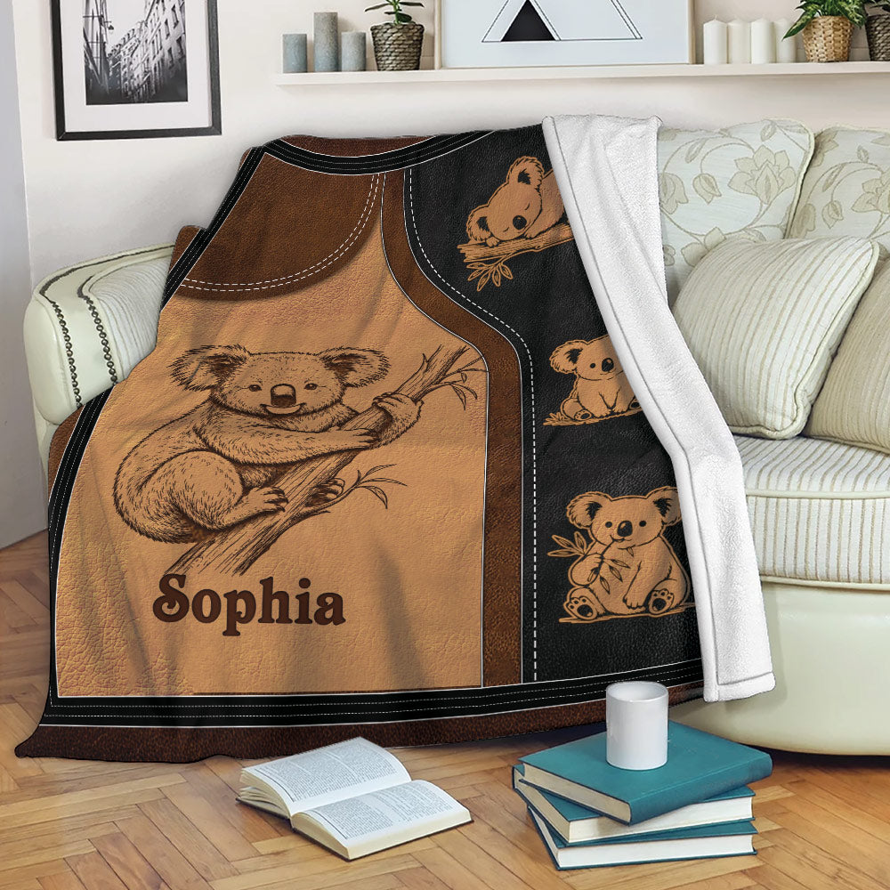 Koala throw blanket displayed on a sofa with cozy Australian wildlife illustrations