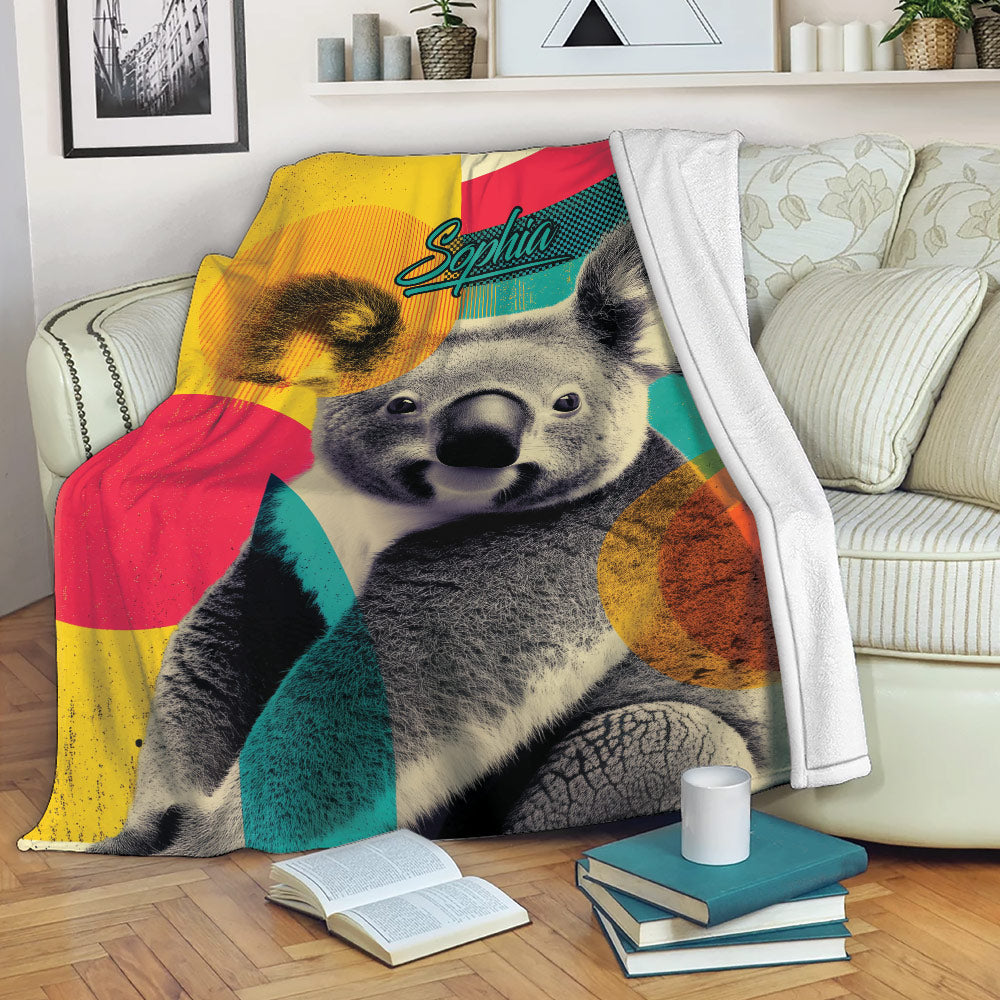 Colorful koala blanket draped over a sofa with books and modern living room decor