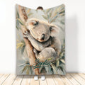 Koala throw blanket featuring a sleeping koala resting on a tree among soft eucalyptus leaves