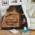 Shark throw blanket draped over a sofa with ocean-inspired artwork and multiple shark silhouettes