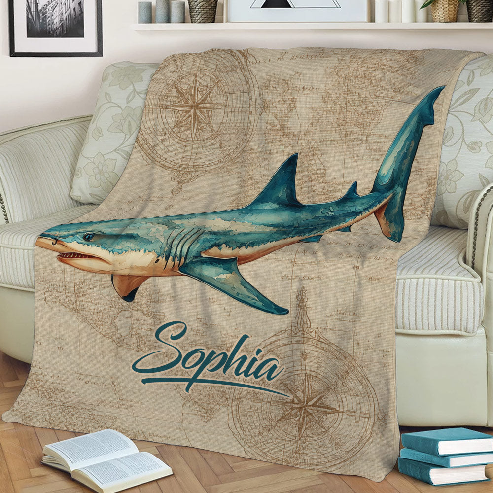 Ocean shark throw blanket displayed on a sofa with illustrated nautical map details