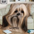 Long-haired Lhasa Apso dog throw blanket styled on a sofa with books nearby