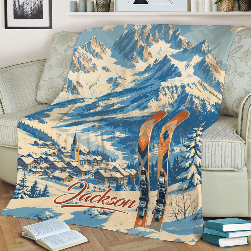 Custom skiing throw blanket displayed on a couch with alpine landscape and ski artwork