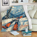 Skiing throw blanket displayed on a couch with colorful skis and mountain landscape artwork