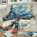 Skiing blanket draped over a sofa featuring snowy peaks, pine trees, and vivid orange skis