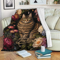 Tabby cat throw blanket with colorful flowers draped across a couch in a cozy reading space