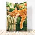 Orange tabby cat sleeping on a green armchair in a cozy floral living room blanket design