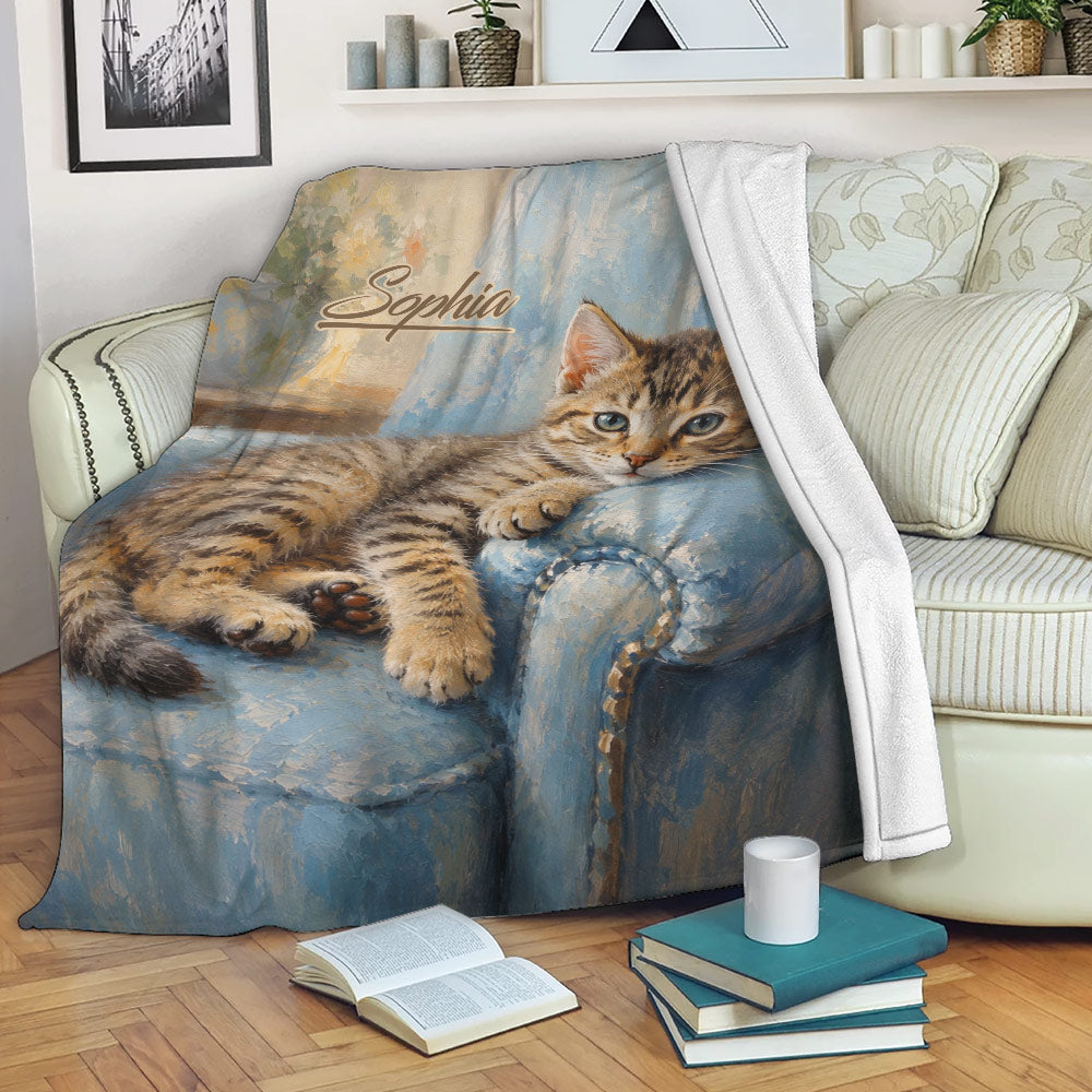 Tabby cat blanket draped over a sofa in a cozy reading room setting
