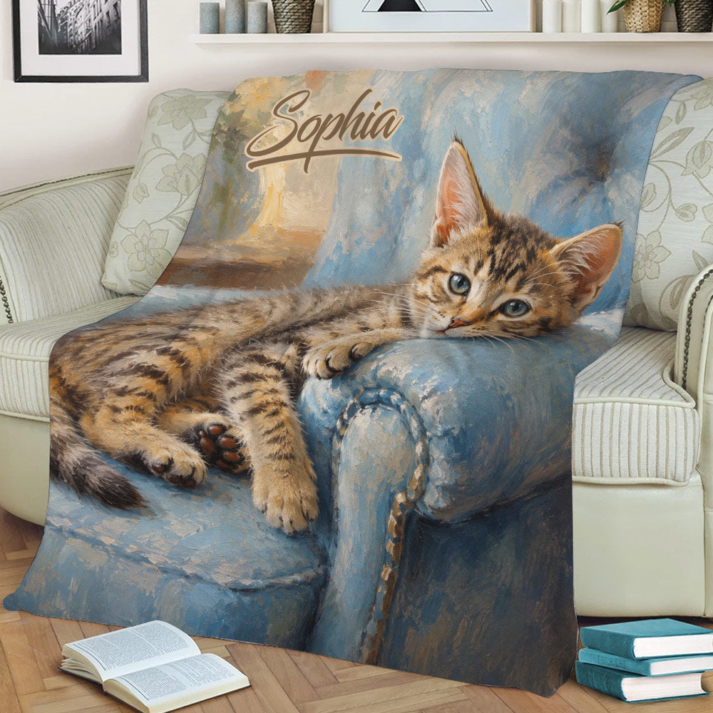 Close view of a tabby cat throw blanket styled across a comfortable sofa