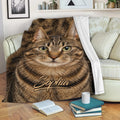 Tabby cat blanket draped over a sofa with realistic brown cat artwork in a cozy room