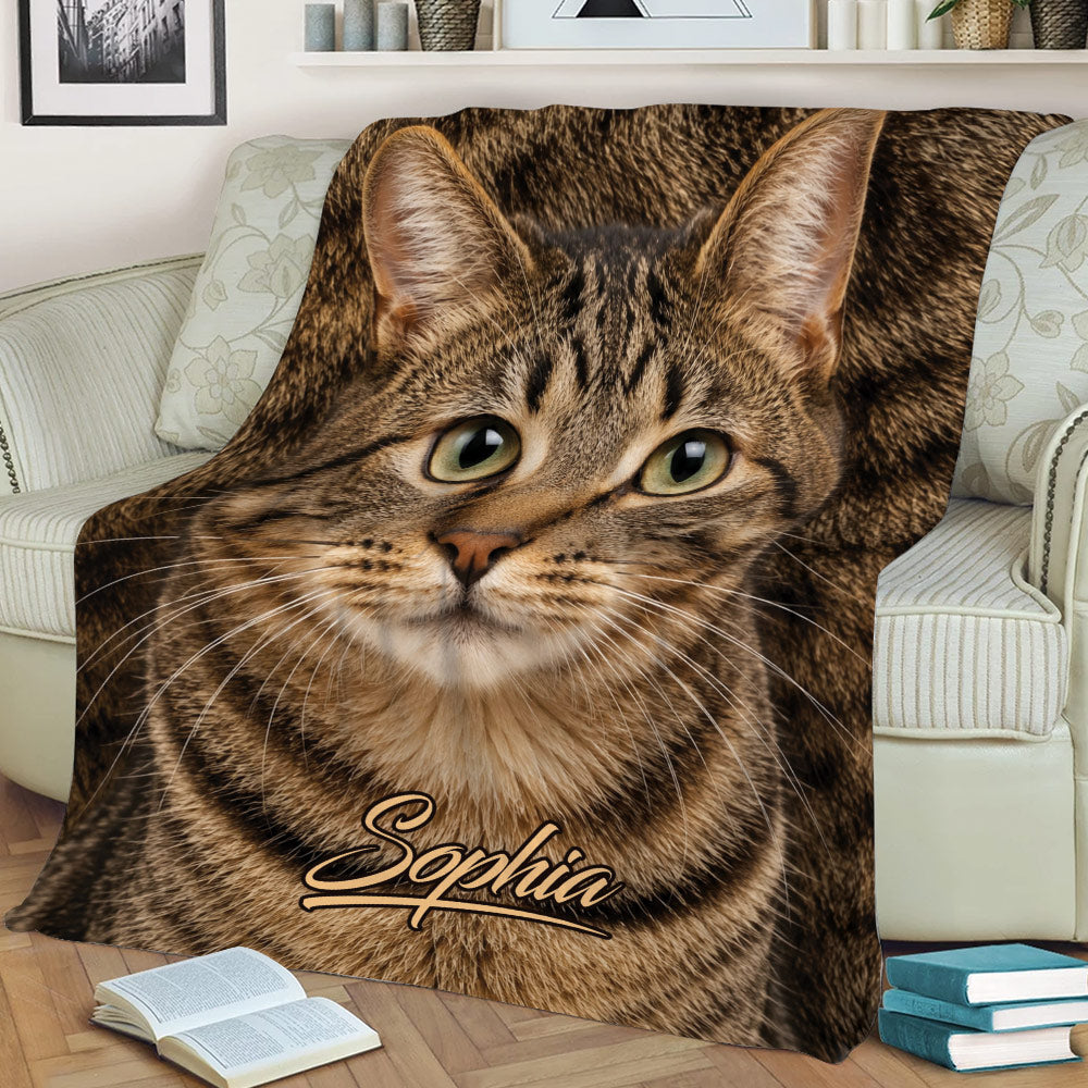 Close view of a tabby cat throw blanket styled on a sofa with detailed brown fur artwork