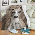 Whippet throw blanket draped over a sofa with realistic brindle dog artwork in a cozy living room