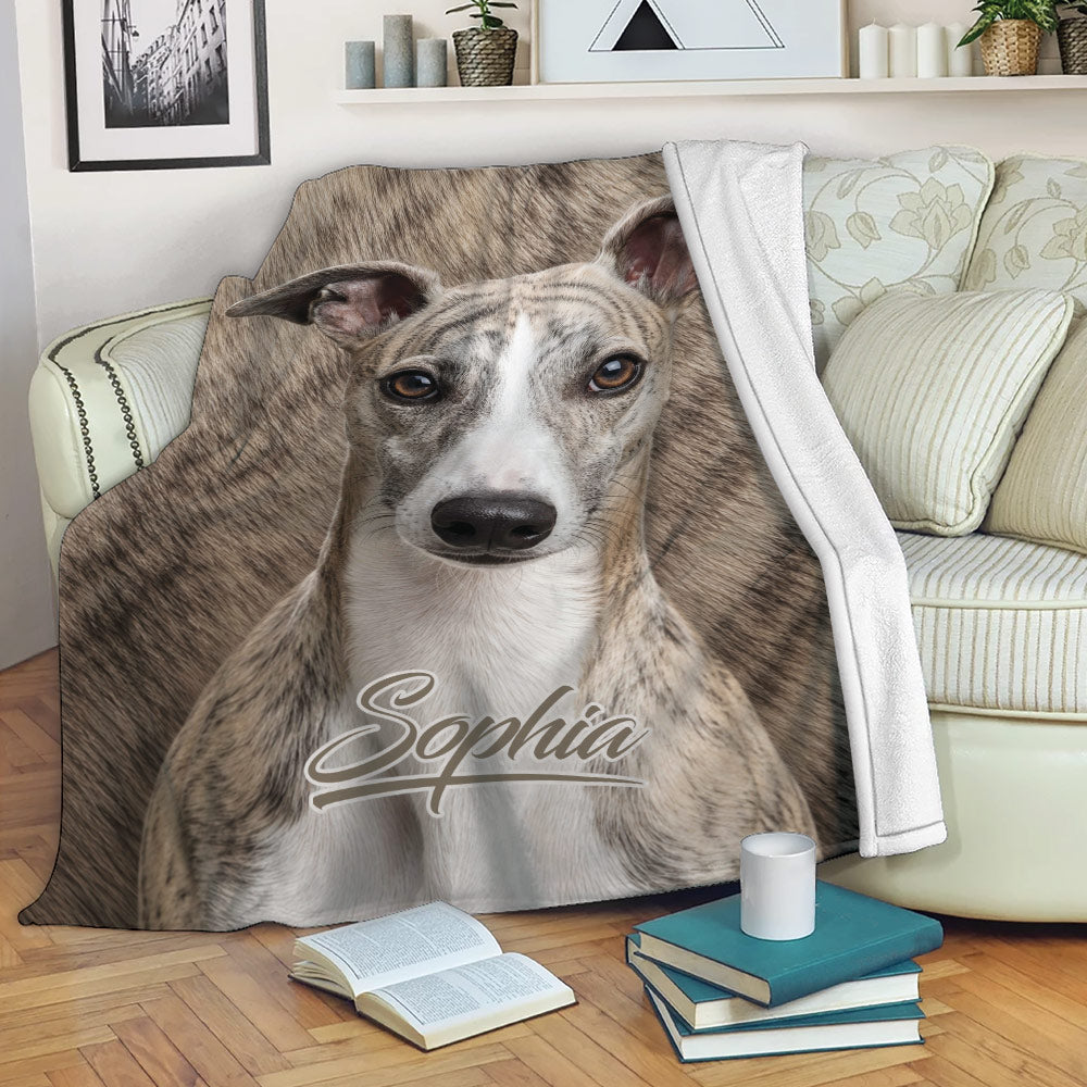 Whippet throw blanket draped over a sofa with realistic brindle dog artwork in a cozy living room