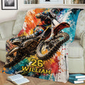 Motocross throw blanket draped over a sofa with dynamic dirt bike rider artwork