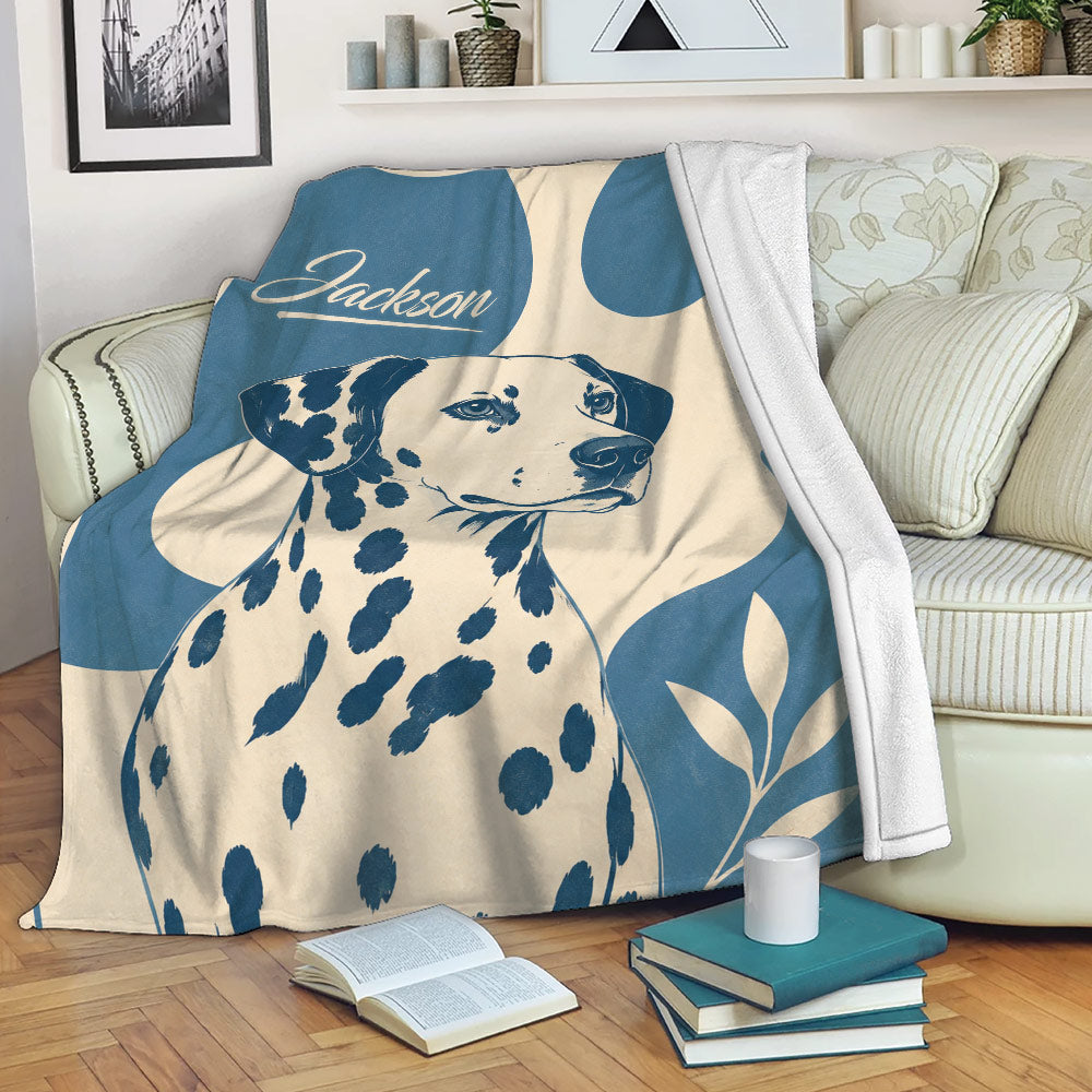 Dalmatian blanket draped over a sofa with bold blue and cream dog artwork
