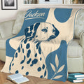 Close view of a Dalmatian throw blanket featuring spotted dog artwork and leafy accents