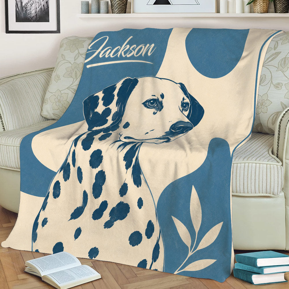 Close view of a Dalmatian throw blanket featuring spotted dog artwork and leafy accents