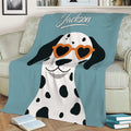Close view of a Dalmatian blanket with heart-shaped sunglasses in a cozy living room