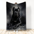 Black Cane Corso dog artwork on a dark watercolor throw blanket held up indoors