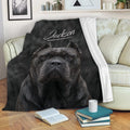 Cane Corso blanket displayed on a sofa with bold black dog artwork in a cozy living room