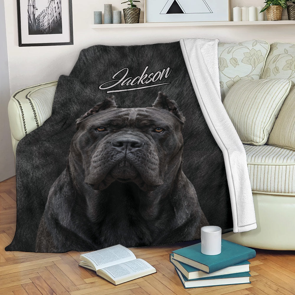 Cane Corso blanket displayed on a sofa with bold black dog artwork in a cozy living room