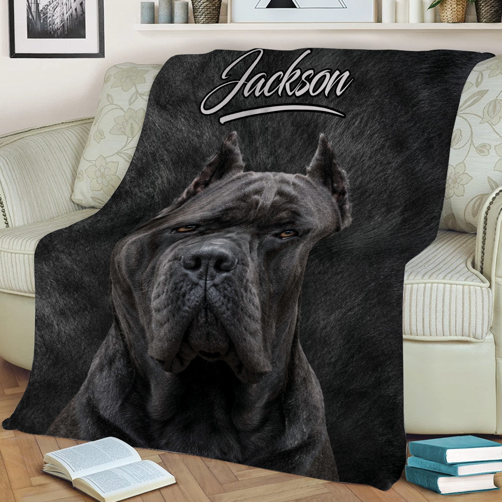 Cane Corso throw blanket draped across a sofa, featuring dramatic black dog artwork
