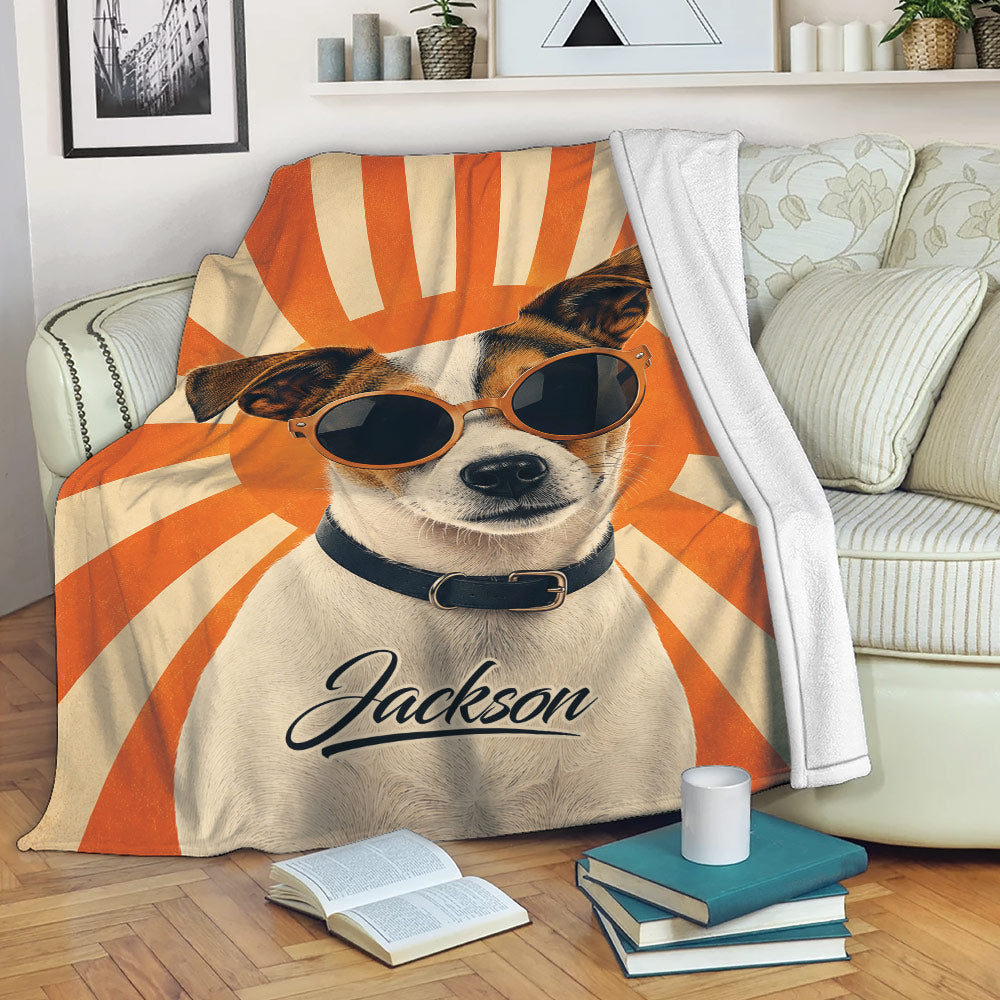 Jack Russell dog blanket displayed on a sofa with sunglasses and bold orange sunburst artwork