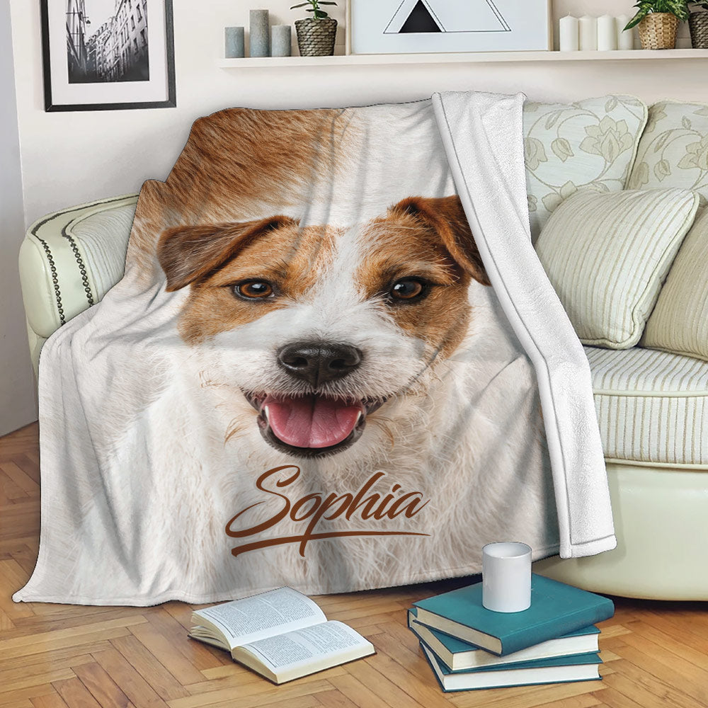 Jack Russell throw blanket draped over a sofa with cozy dog artwork in a living room