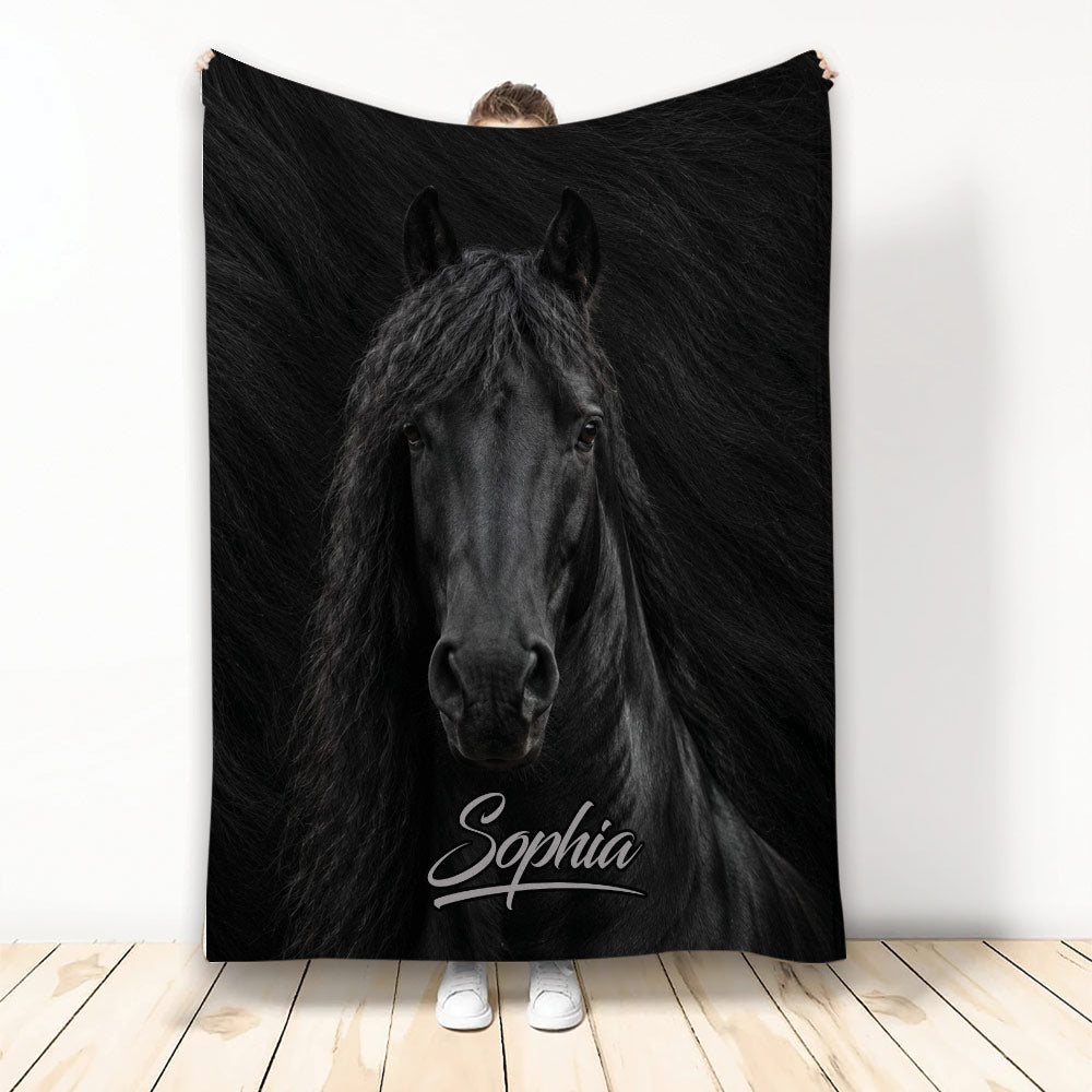 Black horse portrait blanket displayed upright with dramatic dark artwork and a cozy home setting