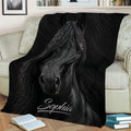 Detailed black horse artwork blanket draped across a sofa in a stylish living room