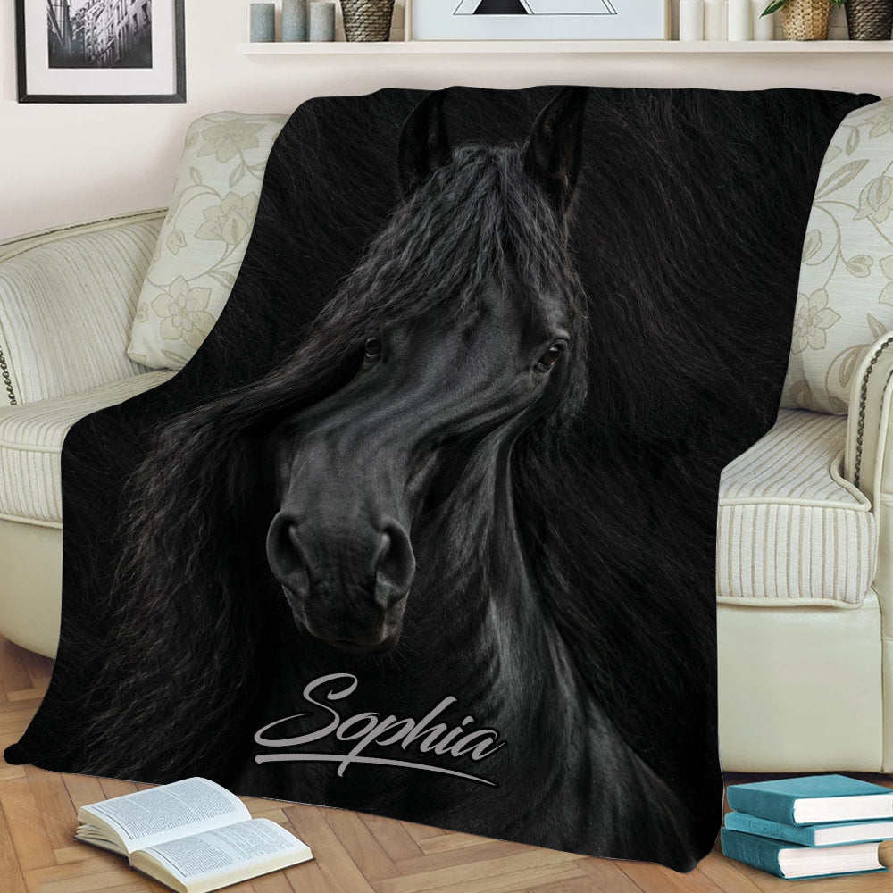 Detailed black horse artwork blanket draped across a sofa in a stylish living room